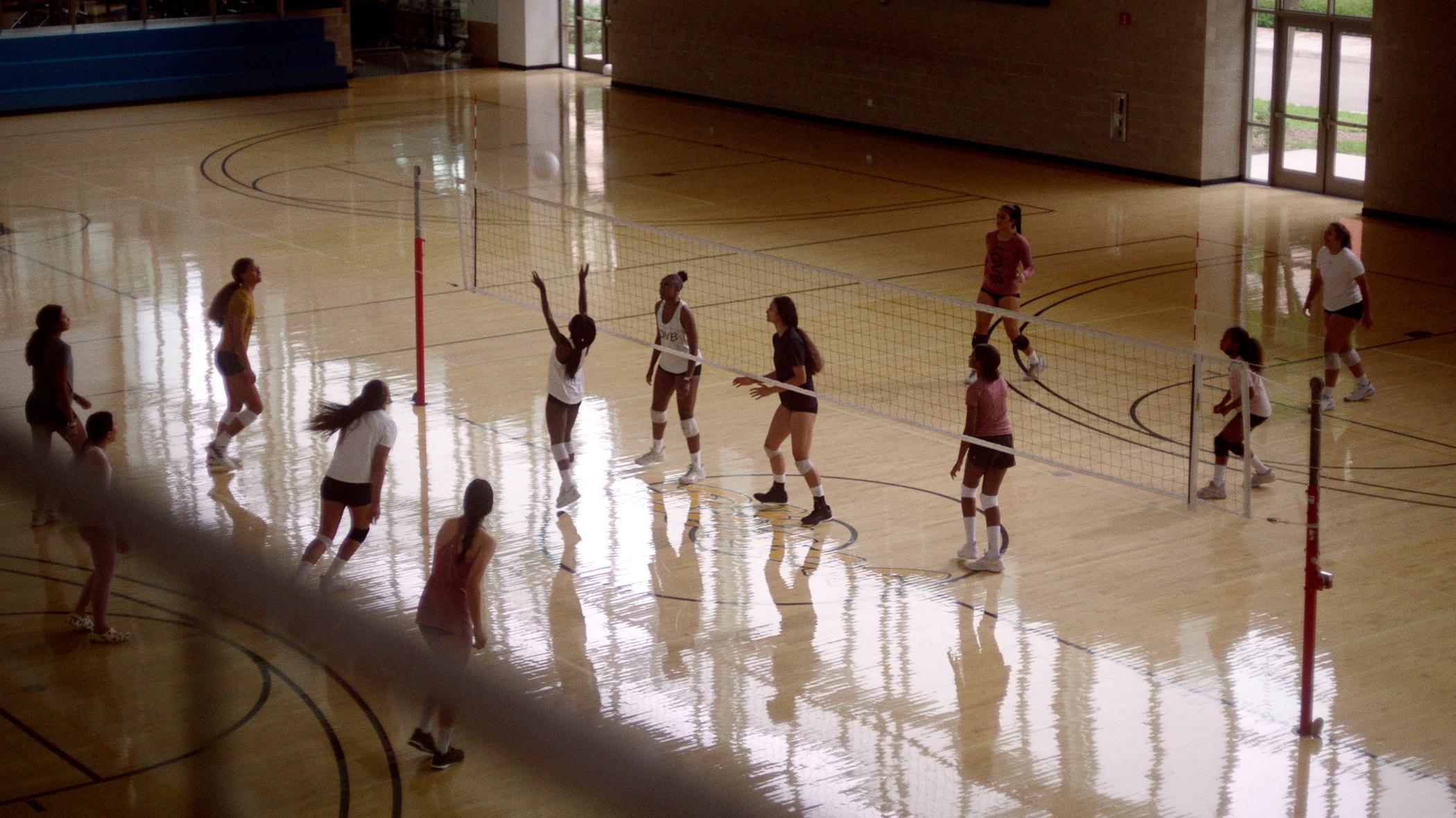 Teenagers playing volleyball